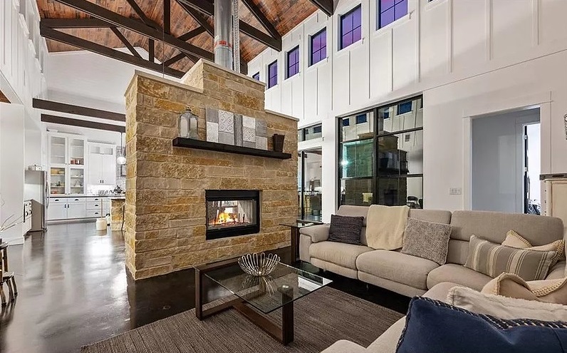 Living room fireplace, high ceiling, exposed beams, Jerrall, Texas, Homestead, barndominium. Rob Sanders Designer